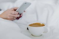 Kaboompics - Woman taking photo of coffee in bed
