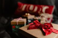 Kaboompics - Christmas Gift Box with a Red Bow and Joy Pillow