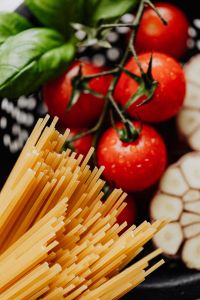 Kaboompics - Uncooked Spaghetti with Tomatoes, Basil and Garlic, Portrait Flat Lay