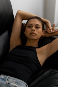 Kaboompics - Woman Reclining on Black Leather Chair with Arms Behind Head