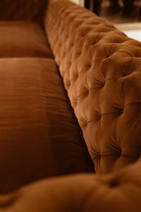 Kaboompics - Low-Angle View Along the Orange Velvet Tufted Sofa