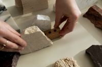Kaboompics - Hands Arranging Stone and Wood Material Samples