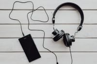 Kaboompics - Black Phone and Over-Ear Headphones on White Wooden Boards