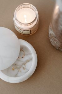 Kaboompics - Candle and Jewelry Dish on Beige Travertine Table