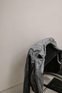 Kaboompics - Black Leather Jacket Draped on Chrome Chair