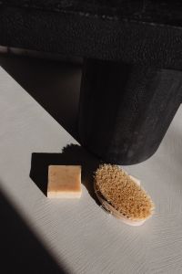Kaboompics - Natural Soap and Dry Body Brush on Textured Surface
