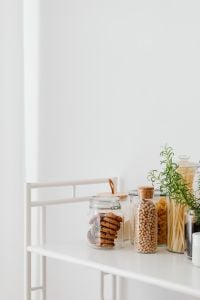 Kaboompics - Minimal Pantry Jars of Pasta and Chickpeas on a Bright White Kitchen Counter