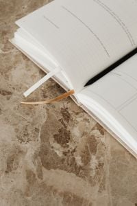 Kaboompics - Open Planner and Pens on a Marble Table, Minimal Workspace Flat Lay
