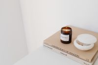 Kaboompics - Amber Candle and White Bowl Styled on Art Books