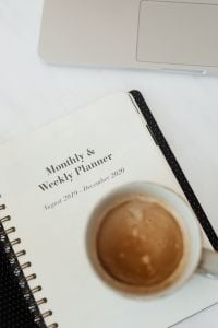 Kaboompics - Neutral Home Office with Laptop, Coffee and Black Floral Planner