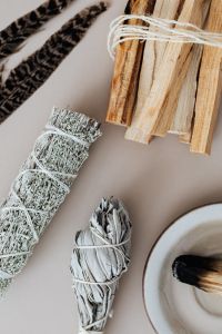Kaboompics - Sage Smudge Bundle, Palo Santo and Feathers for a Home Cleansing Ritual