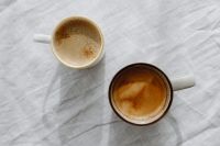 Kaboompics - Two Cappuccino Cups on White Linen for Cozy Coffee and Lifestyle Content