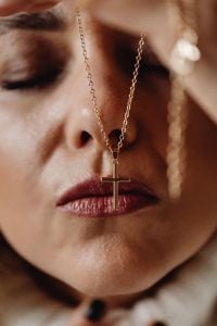 Kaboompics - Close-Up Portrait of a Woman Wearing a Gold Cross Necklace