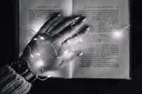 Kaboompics - Female hand, fairy lights, book