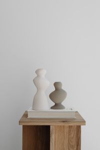Kaboompics - White and Taupe Ceramic Vases on an Oak Side Table with a Book