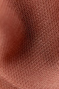 Kaboompics - Soft pink sheer knit fabric draped close-up