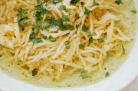 Kaboompics - Macro Detail of Rosół Noodles and Parsley in Clear Chicken Broth