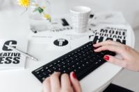 Kaboompics - Female hands typing on the remote wireless computer keyboard