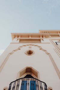 Kaboompics - Low-Angle View of a Cream Historic Facade with Ornate Moldings in Madrid