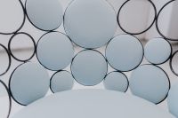 Kaboompics - Sculptural Lounge Chair with Circular Backrest and Pale Blue Upholstery