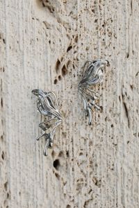 Kaboompics - Silver Leaf Earrings on a Textured Stone Surface