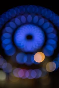 Kaboompics - Blue Ferris Wheel Bokeh with a Bright Center and Amber Orb