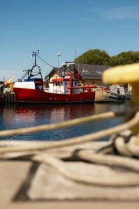 Kaboompics - Red Fishing Boat Docked in Quiet Harbor Marina