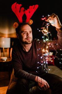 Kaboompics - Soft-Focus Portrait of Man with Reindeer Antlers and Holiday Lights