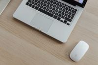 Kaboompics - Close-Up of Laptop and White Mouse on a Pale Wood Home Office Desk