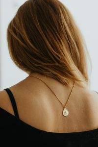 Kaboompics - Back View of Woman with Gold Necklace on Black Top