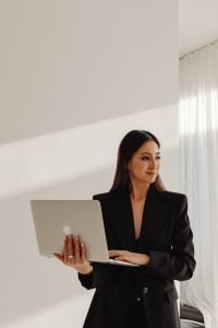 Kaboompics - Businesswoman Holding a Laptop in a Bright Interior