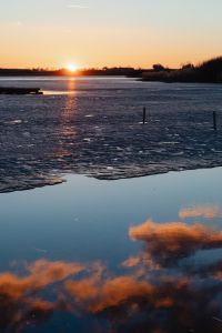 Kaboompics - Sunset Sky Reflected in Open Water Beside Broken Ice