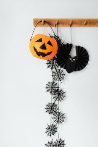 Kaboompics - Halloween Pumpkin Bucket with Bat, Spiderwebs and Black Hanging Decorations