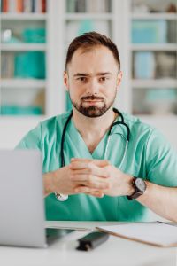 Kaboompics - Doctor With Folded Hands and Stethoscope