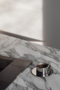 Kaboompics - Chrome Coffee Cup on Arabescato Marble with Sunlit Shadows