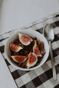 Kaboompics - Vertical Breakfast Bowl with Granola and Figs on a Gray Plate, Spoon and Gingham Napkin