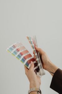 Kaboompics - Overhead View of Hands Holding Coral Color Swatches