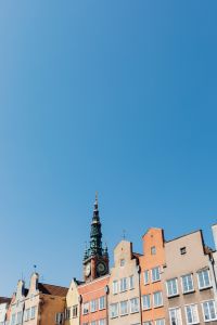 Kaboompics - Gdańsk Old Town Clock Tower and Colorful Rooftops Under Blue Sky