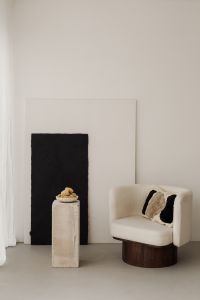 Kaboompics - Cream Armchair and Black Artwork in a Minimalist Room