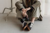 Kaboompics - DSLR Camera and Black Sneakers in Young Photographer Outfit