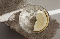 Kaboompics - Water Being Poured Into a Lemon-Garnished Glass