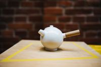 Kaboompics - White Ceramic Teapot on Table with Yellow Geometric Lines