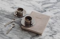 Kaboompics - Two Chrome Coffee Cups on Books and Arabescato Marble