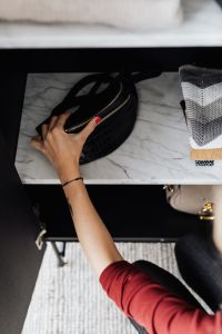 Kaboompics - Woman putting clothes on shelf