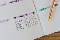 Kaboompics - Close-Up of Habit Tracker and Gold Pen