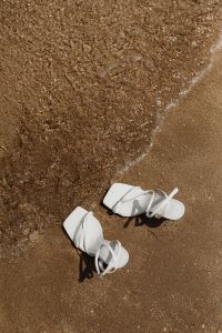 Kaboompics - White Sandals with Broad Water Background in a Beach Flat Lay