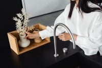 Kaboompics - Woman Arranging Dried Flowers at a Kitchen Sink