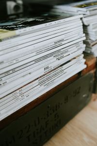 Kaboompics - Stack of Design Magazines on a Wooden Coffee Table, Modern Black-and-White Living Room Detail