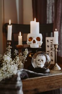 Kaboompics - Halloween Skull Candle Display with Crystal Skull Ball and Flowers