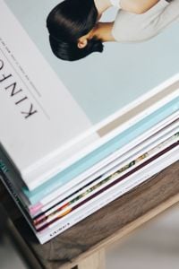 Kaboompics - Stack of magazines on the wooden stool